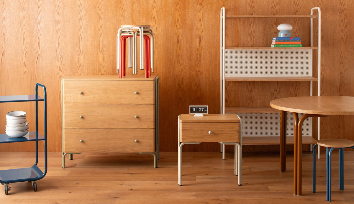 studio set up with tables, cabinets, and nightstand with colorful legs