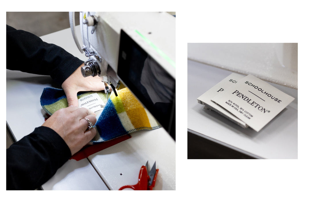 Hands sewing a Pendleton label onto a colorful wool swatch; nearby stack of labels reading SCHOOLHOUSE and PENDLETON on a worktable