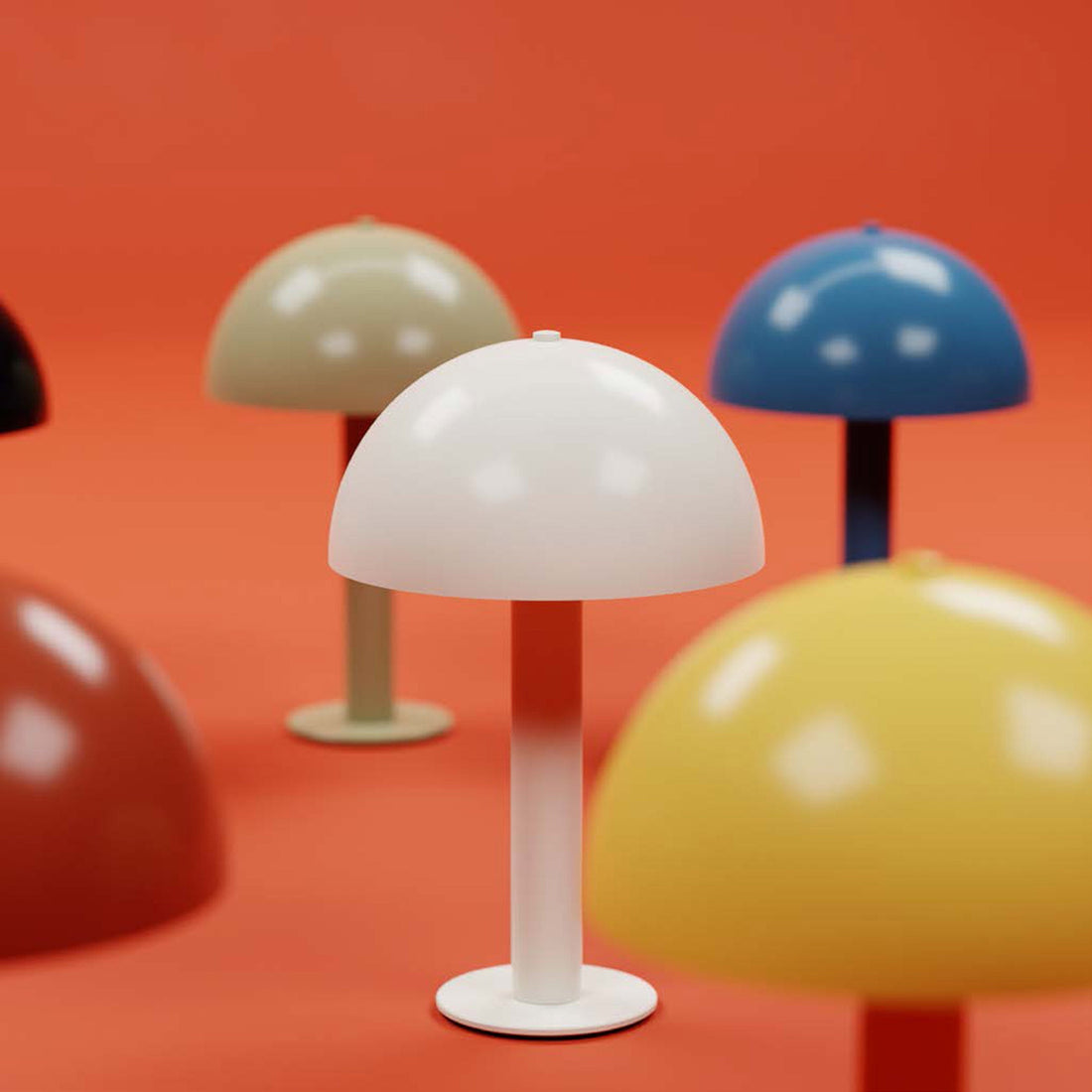 Close-up front of white mushroom table lamp showing dome shade and stem, with other colored lamps on orange background