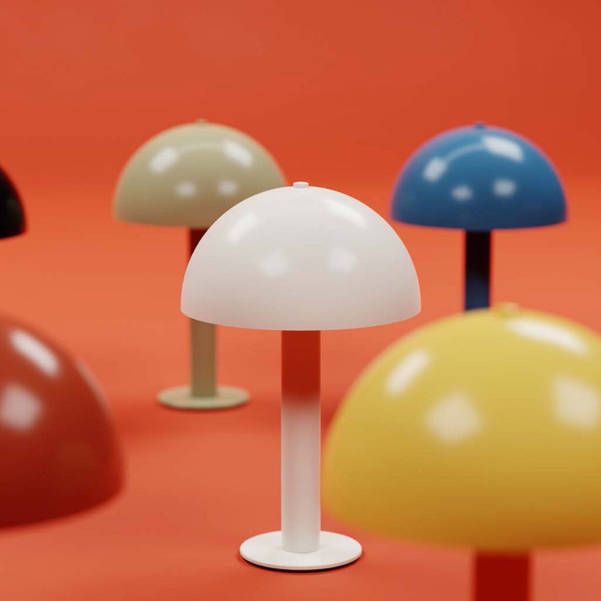 Close-up front of white mushroom table lamp showing dome shade and stem, with other colored lamps on orange background