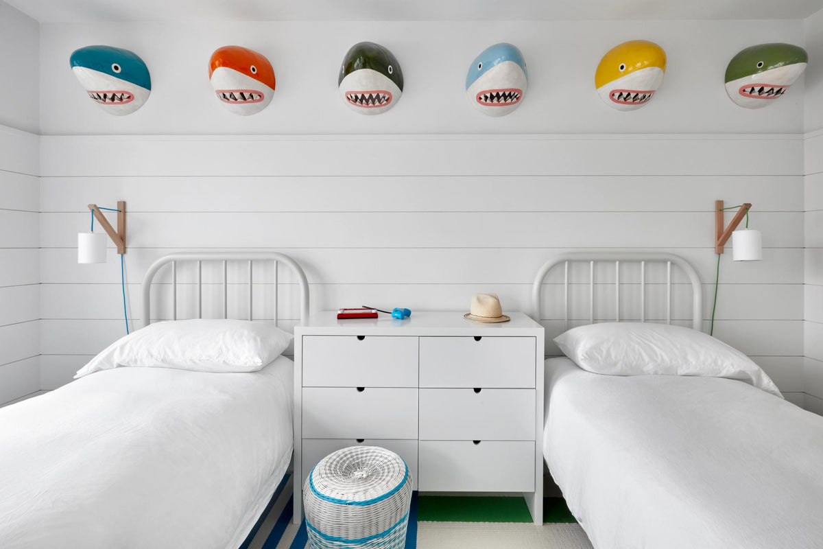Kids room with two beds and shark busts
