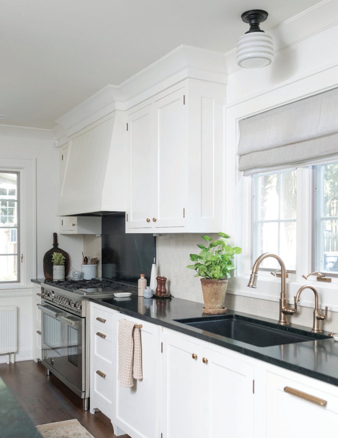 White kitchen with schoolhouse light fixture