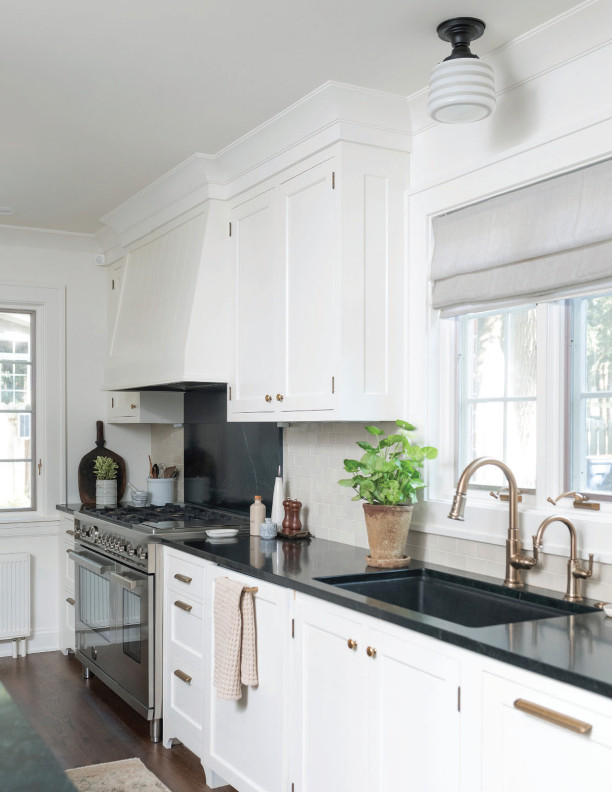 White kitchen with schoolhouse light fixture
