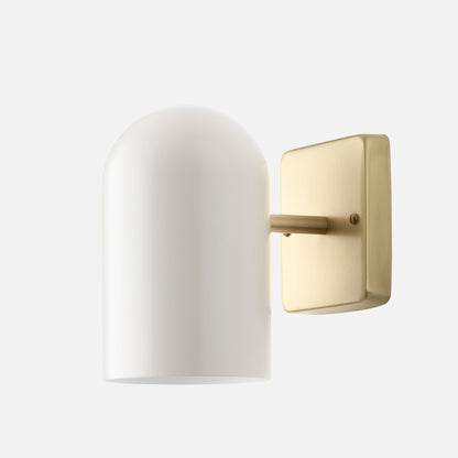Close-up of Allegheny 4.5 inch indoor/outdoor sconce showing white cylindrical glass shade and brushed brass backplate on white background