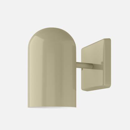 Close-up of Allegheny 4.5” indoor/outdoor sconce showing rounded dome shade, short arm, and rectangular wall plate in matte brass on white background