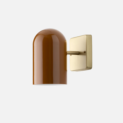 Close-up of Allegheny 4.5-inch indoor/outdoor sconce showing glossy brown shade and satin brass wall plate on light backdrop