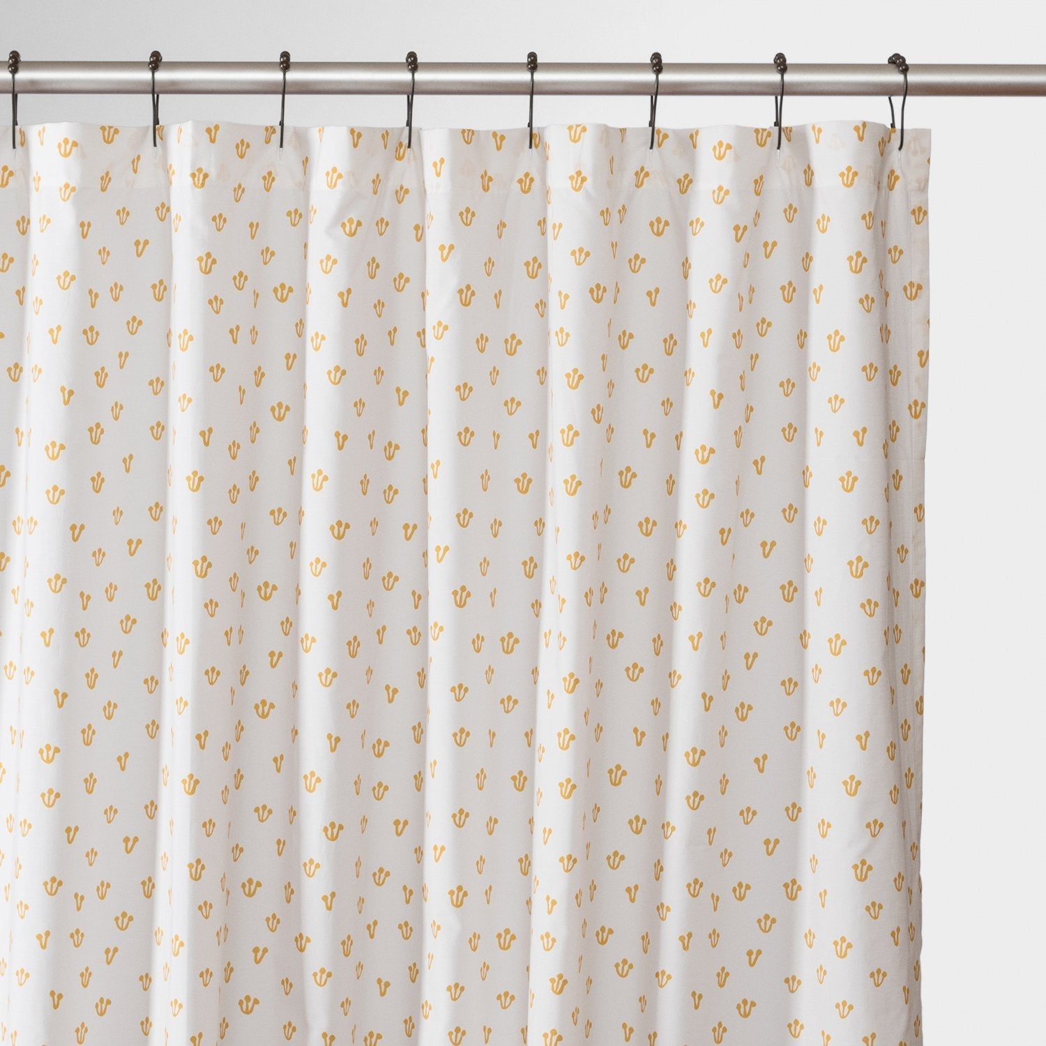 Front view of Thistle shower curtain showcasing honey-yellow thistle pattern on white background with metal shower rod