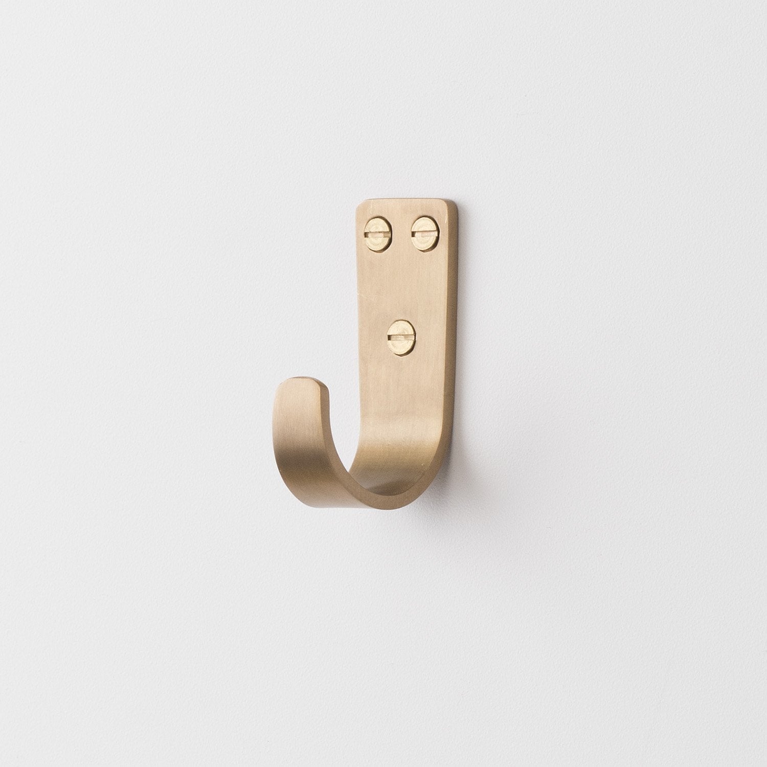 Front view of Thomas Hook showcasing solid brass finish and three mounting holes on a white background