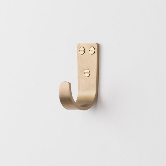 Front view of Thomas Hook showcasing solid brass finish and three mounting holes on a white background