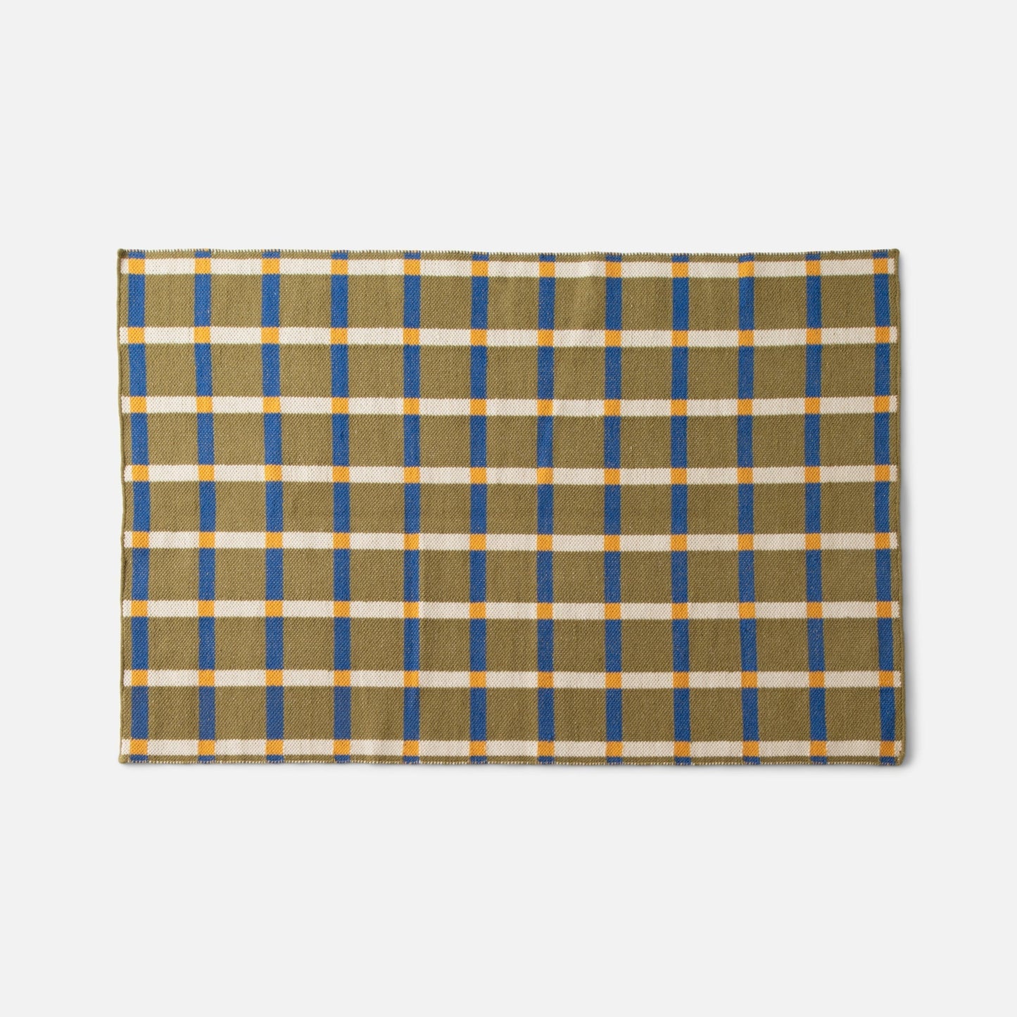 Top-down view of Plaid Wool Reversible Rug showing olive plaid with blue stripes, white grid and orange accents on white background