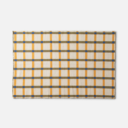 Cropped top-edge view of Plaid Wool Reversible Rug showing yellow and olive plaid with blue checks on white background
