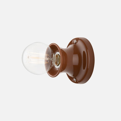 Side view of Alabax Small Flush Mount showcasing tulip-like silhouette, glazed finish, and exposed bulb on white background