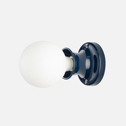 Side view of Alabax small flush mount showing white glass globe and hand-glazed navy ceramic base