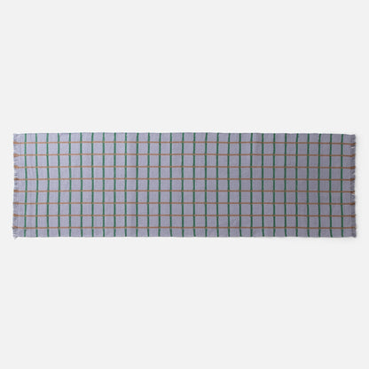 Top view of Cotton Grid Flatweave Rug showing lavender with green and tan grid lines and fringed edges on white background