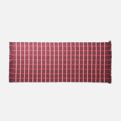 Top view of Cotton Grid Flatweave Rug in red showing grid pattern and fringed ends on white background