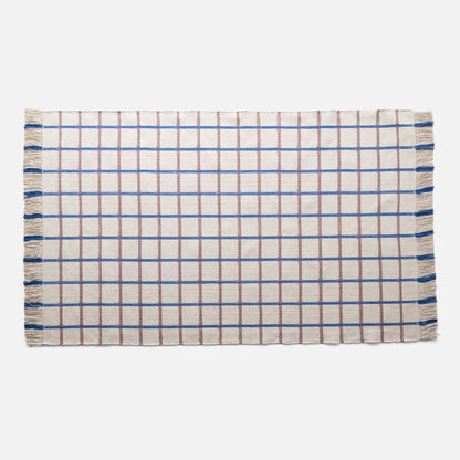 Top view of Cotton Grid Flatweave Rug showing cream field with brown and blue grid and fringed sides on white background