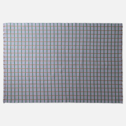 Top view of Cotton Grid Flatweave Rug with green and tan grid lines on pale lavender field and fringed edges