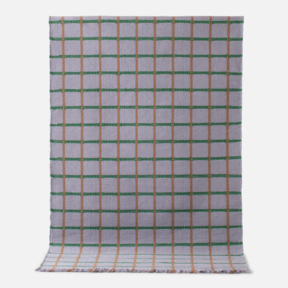 Flatlay of Cotton Grid Flatweave Rug showing grid pattern with green and tan lines on woven cotton background