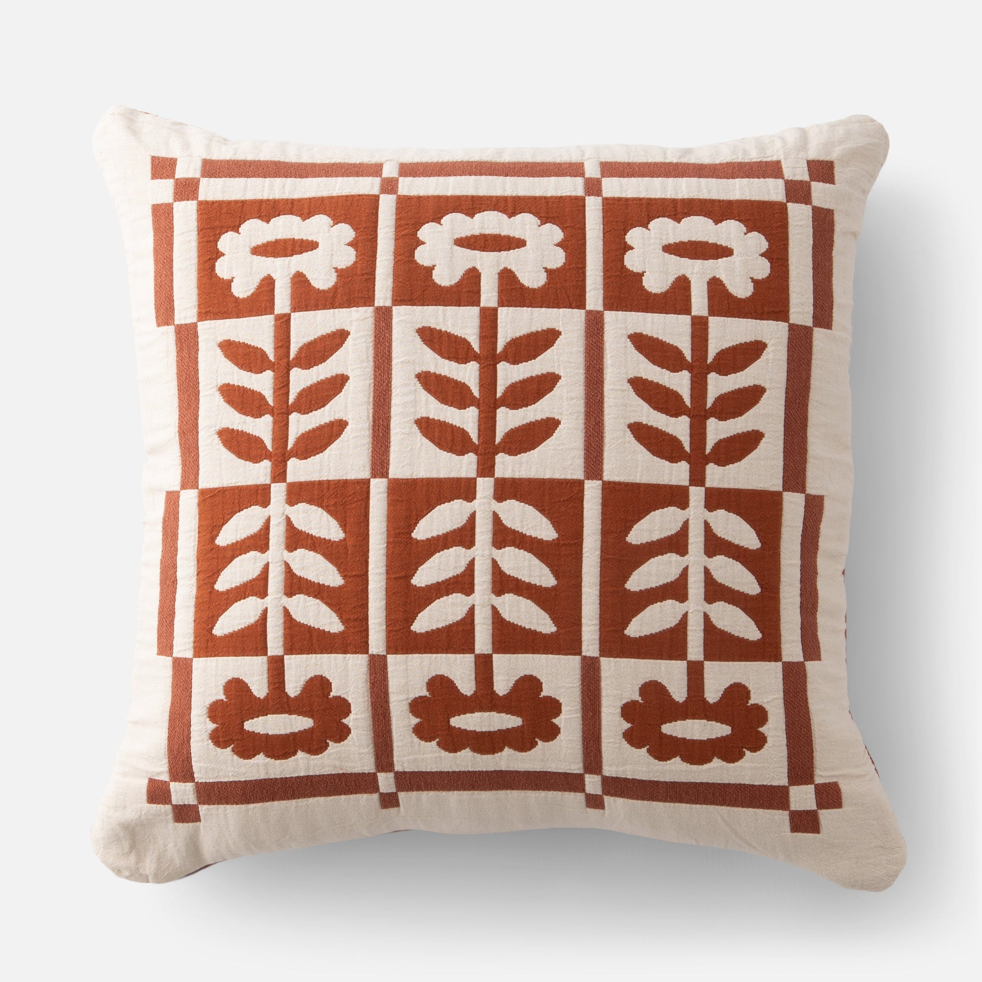 Close up front view of Stillwater Floral Sham showcasing rust and cream mirrored floral applique grid on 100% cotton with light gray background