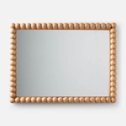Front view of Bobbin Mirror showcasing a rounded bead-style light wood frame on a neutral gray background