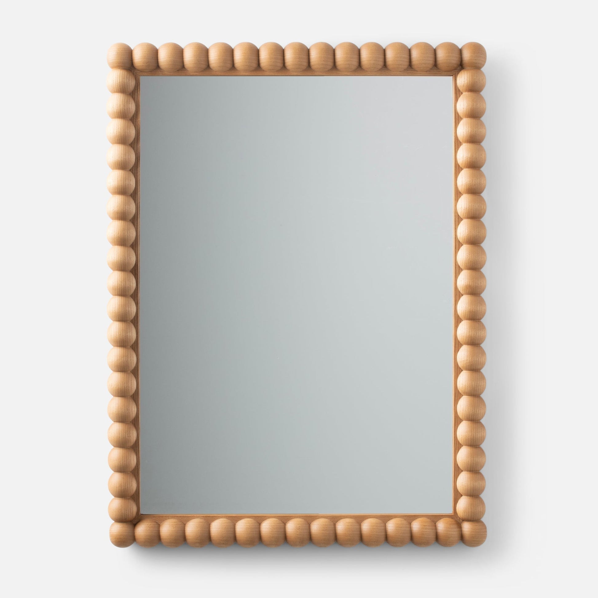 Front view of Bobbin Mirror showcasing light ash beaded wood frame against a white background