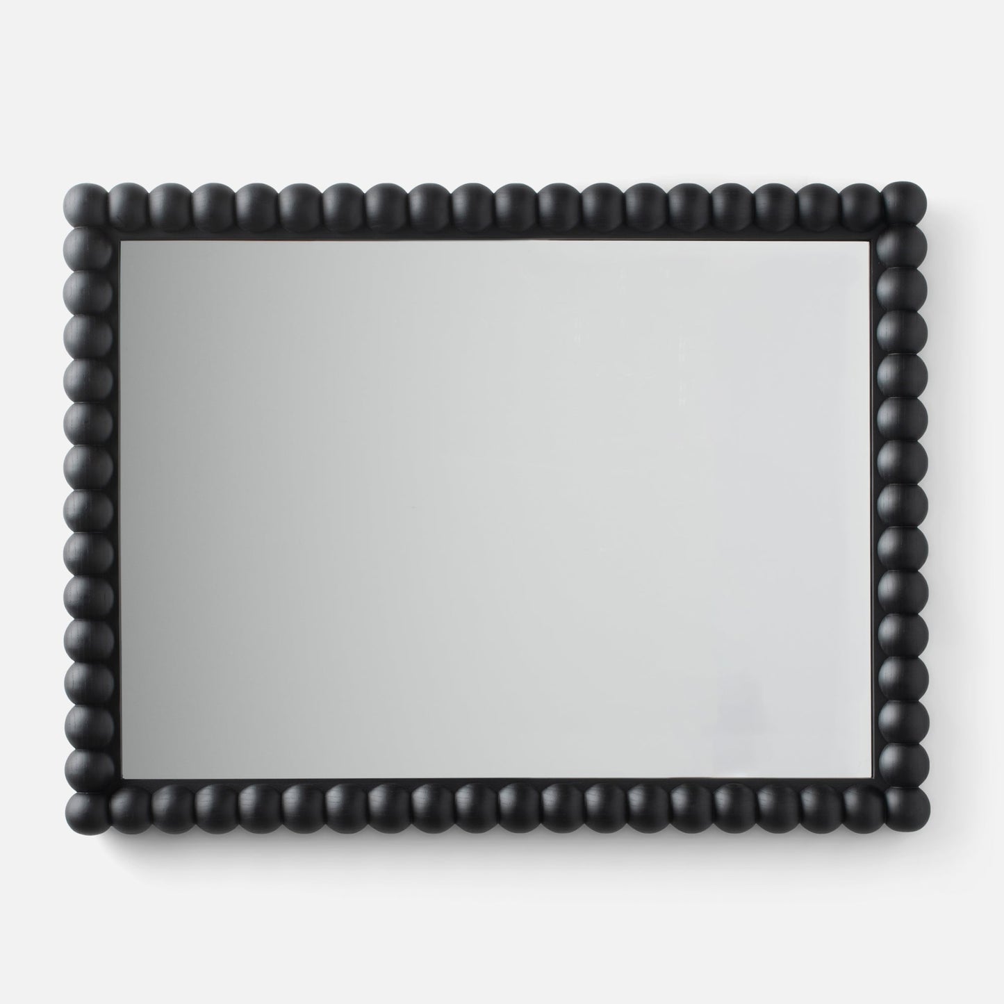 Close-up of Bobbin Mirror showcasing black beaded wooden frame on a white background