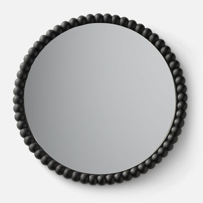 Close-up top view of Bobbin Mirror showing black beaded wooden frame against a white background