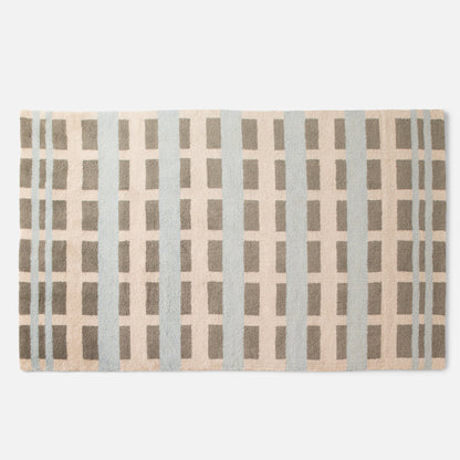 Cropped top view of Network Tufted Wool Rug showing geometric grid in beige, blue, and taupe with high-pile wool texture