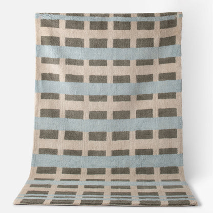 Top view of Network Tufted Wool Rug with blue stripes, gray rectangular grid, and beige high-pile wool