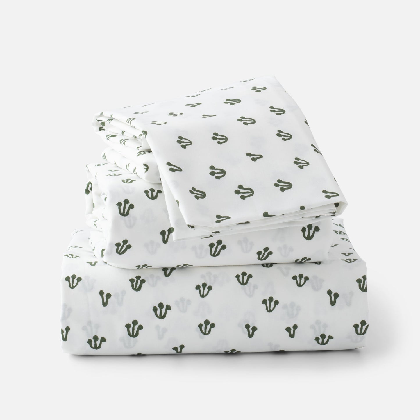 Stacked folded Thistle Percale sheet set showcasing hand-drawn alder green thistle pattern on white background