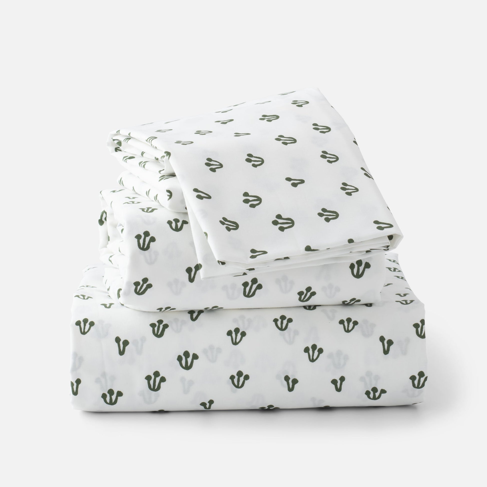 Stacked folded Thistle Percale sheet set showcasing hand-drawn alder green thistle pattern on white background
