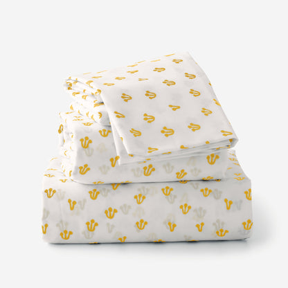 Folded view of Thistle Percale sheet set showcasing hand-drawn yellow thistle pattern with plain white background