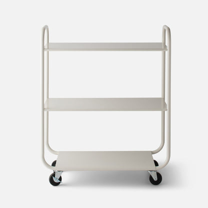 Front view of Miller Storage Cart showcasing three shelves and caster wheels in Shell White gloss on white background
