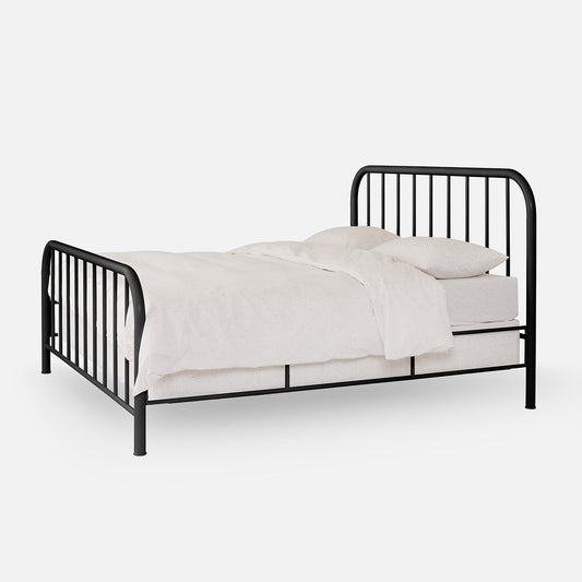 Three-quarter view of Hamilton Bed in black metal with rounded head- and footboard and vertical slats on white background