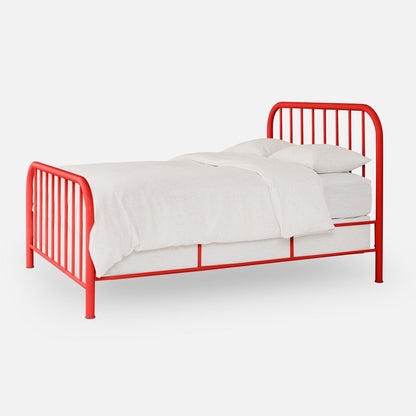Angled side view of Hamilton Bed showing red tubular metal frame with vertical spindles and white bedding on white background