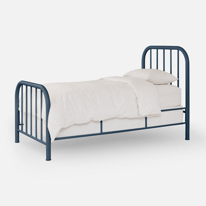 Three-quarter view of Hamilton Bed showcasing blue metal frame with curved headboard and footboard and white bedding on a plain light background