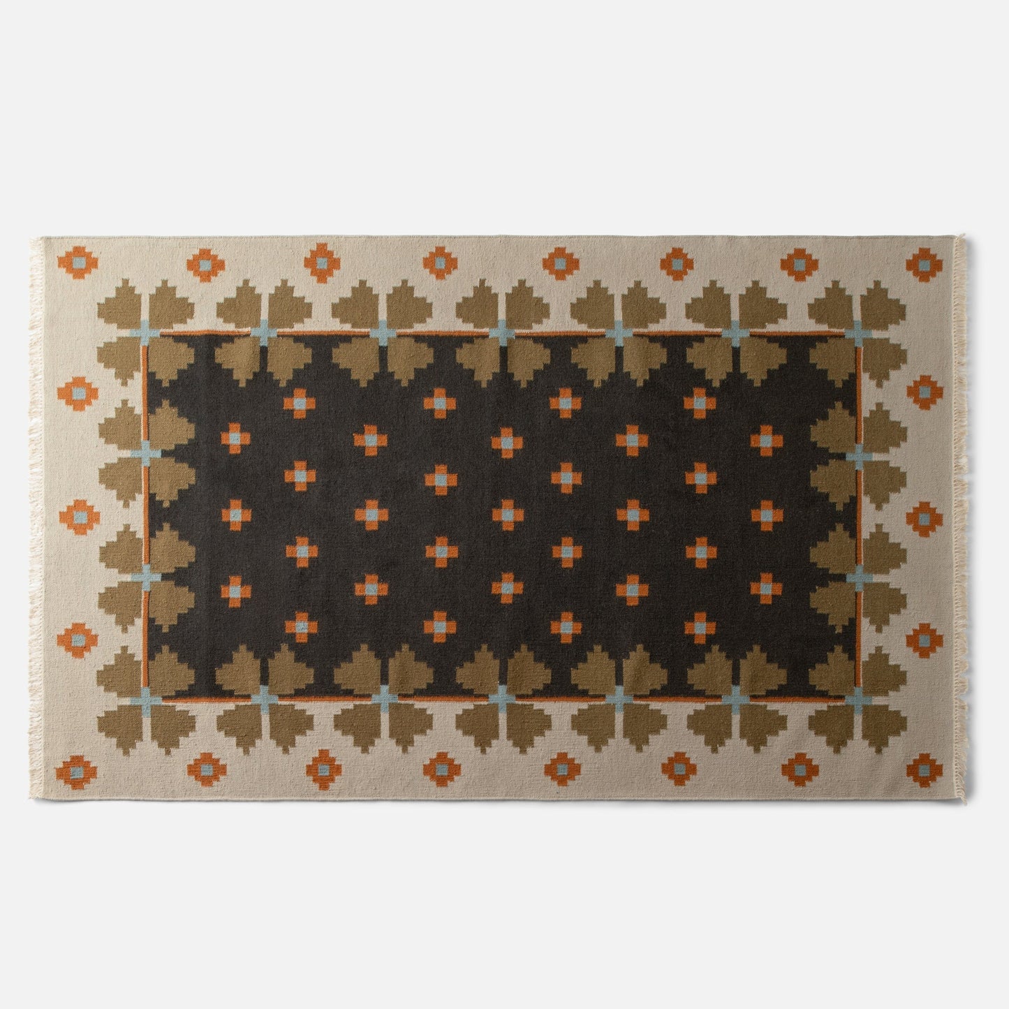 Top edge of Flora Wool Flatweave Rug showcasing geometric folk floral pattern, fringed edge, and dark center