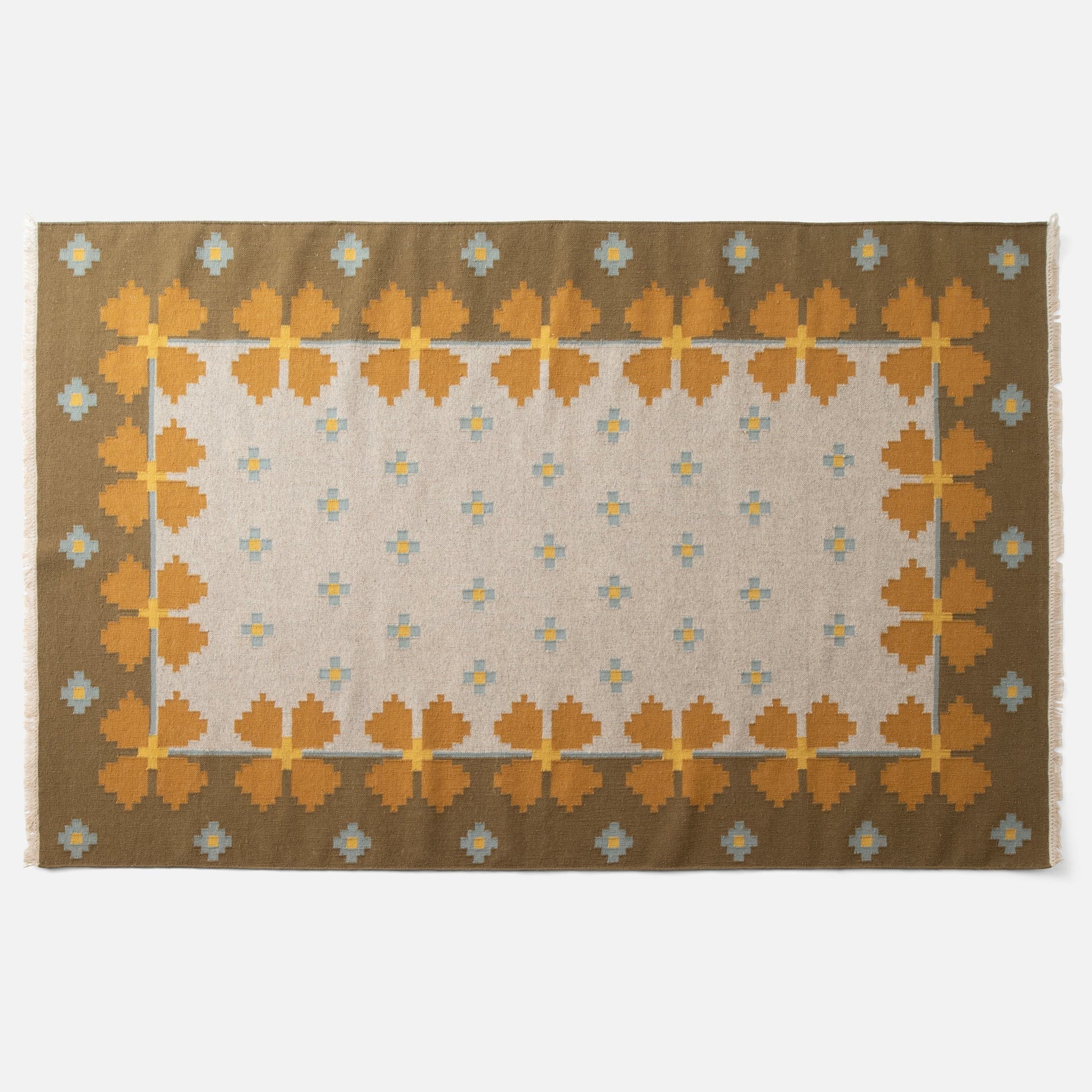 Top-down view of Flora Wool Flatweave Rug showing mustard floral border and small blue-and-yellow motifs on ivory field