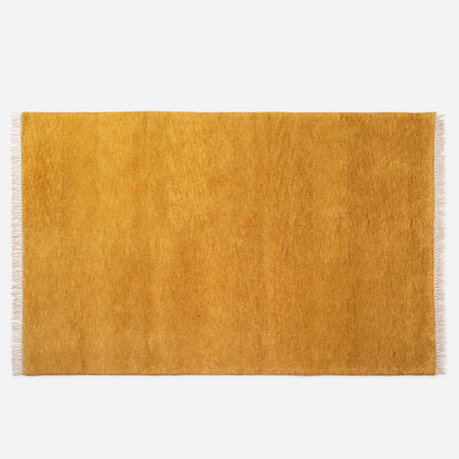 Top-down view of Mesa Wool Rug showing hand-loomed New Zealand wool cut pile and fringed edges on white background