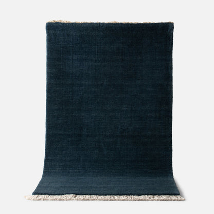 Top view of Mesa Wool Rug showing hand-loomed New Zealand wool pile and fringe on white background