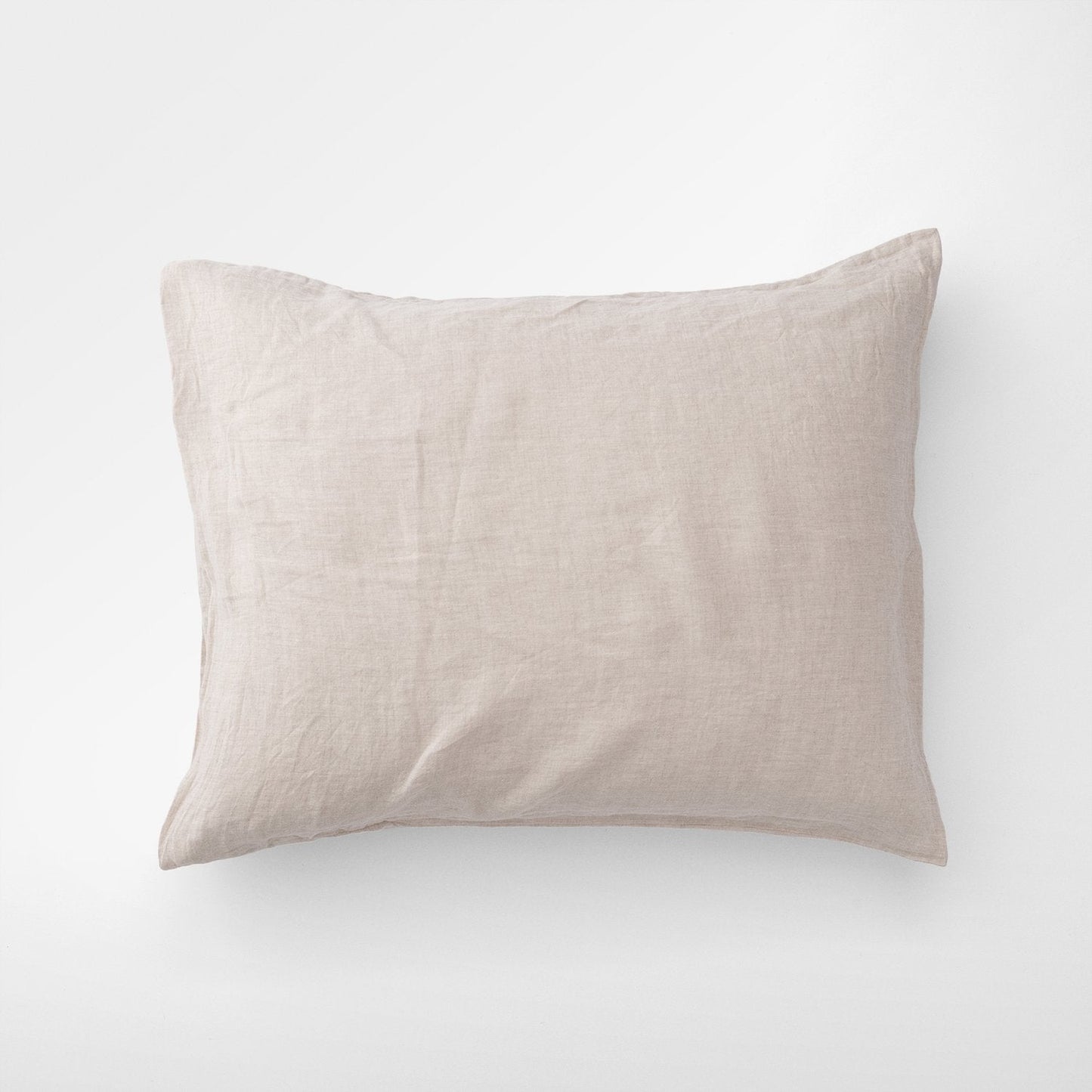 Top-down view of Linen Pillow Sham in Laurel showing washed 100 percent linen texture and relaxed wrinkles on white background
