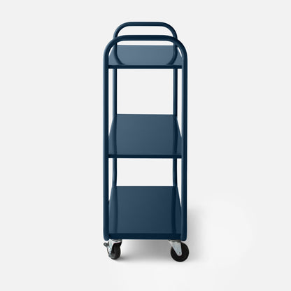 Front close-up of Miller storage cart showcasing glossy navy blue tubular frame, three metal shelves and swivel casters on a white background