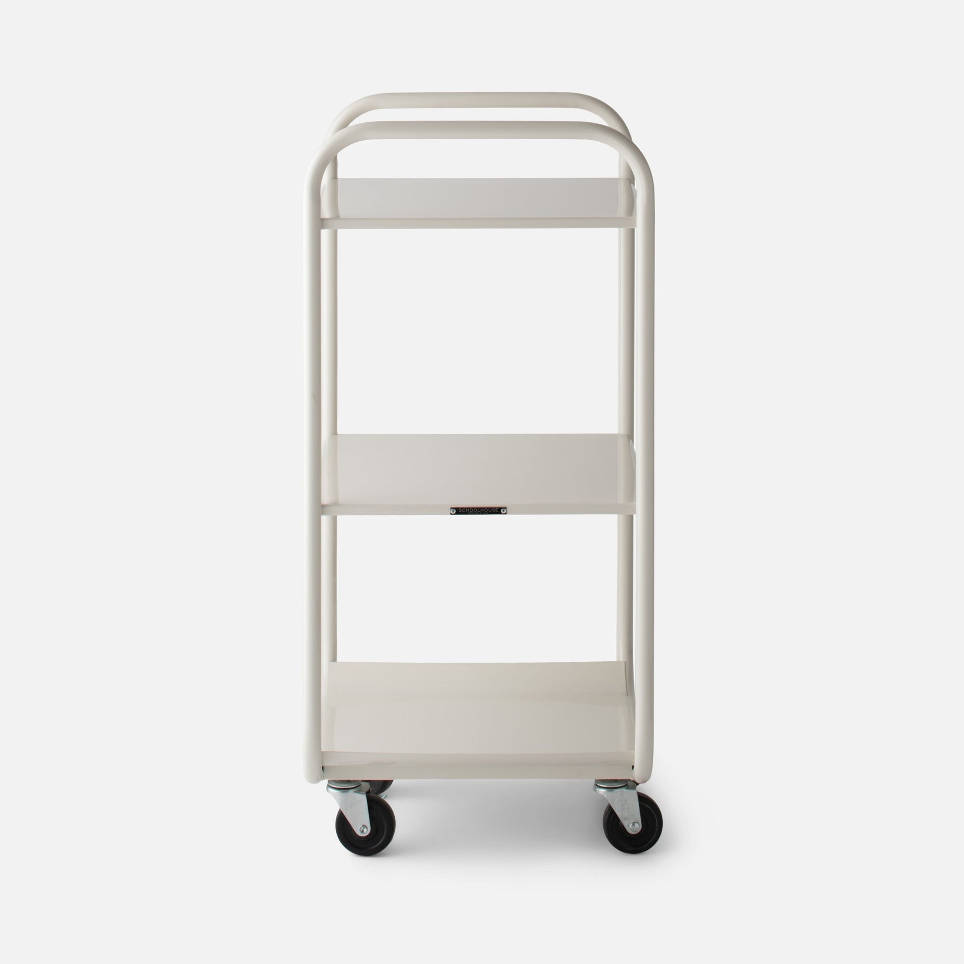 Front view of Miller Storage Cart showing three white metal shelves, rounded tubular handles and caster wheels on a plain studio background