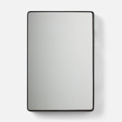 Close-up of Leo Mirror showcasing its thin rounded metal frame and rounded corners on a white background