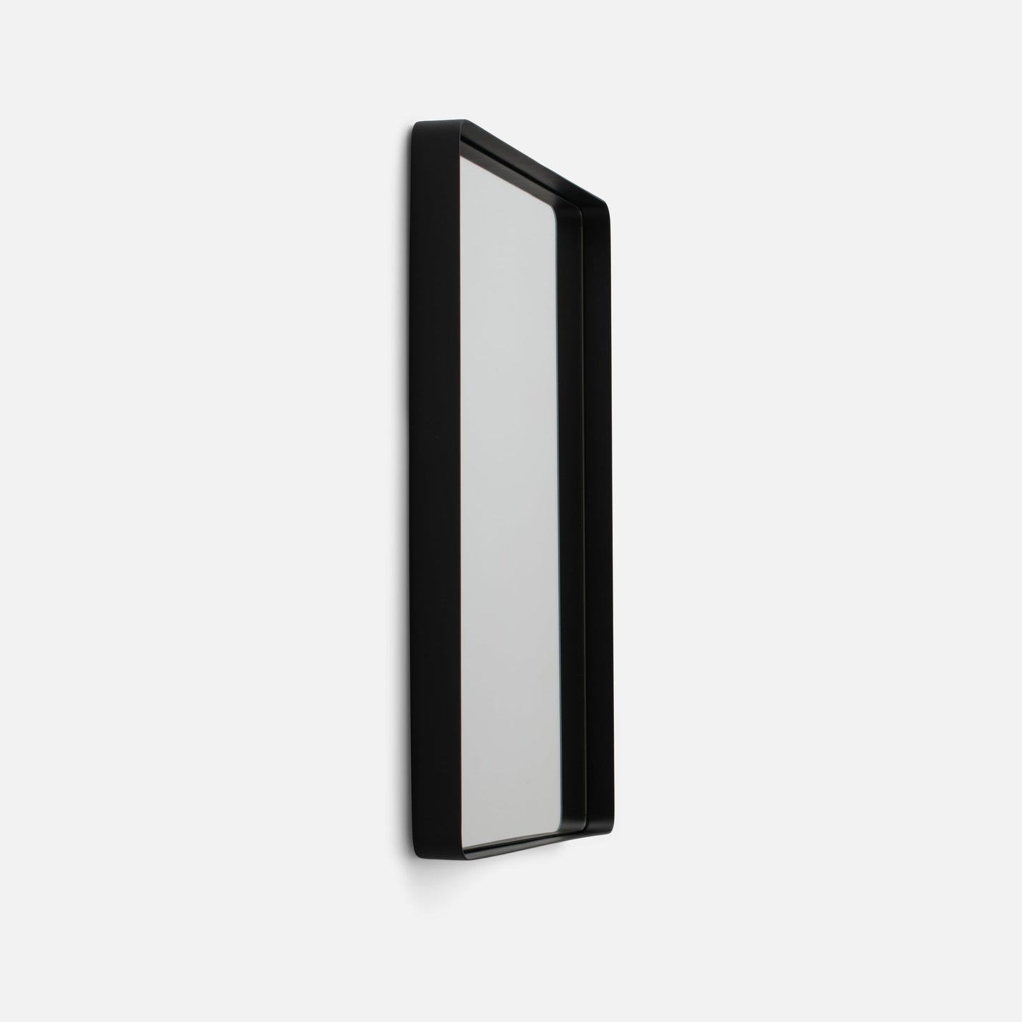 Angled side view of Leo Mirror showcasing black rounded metal frame and slim profile on white background