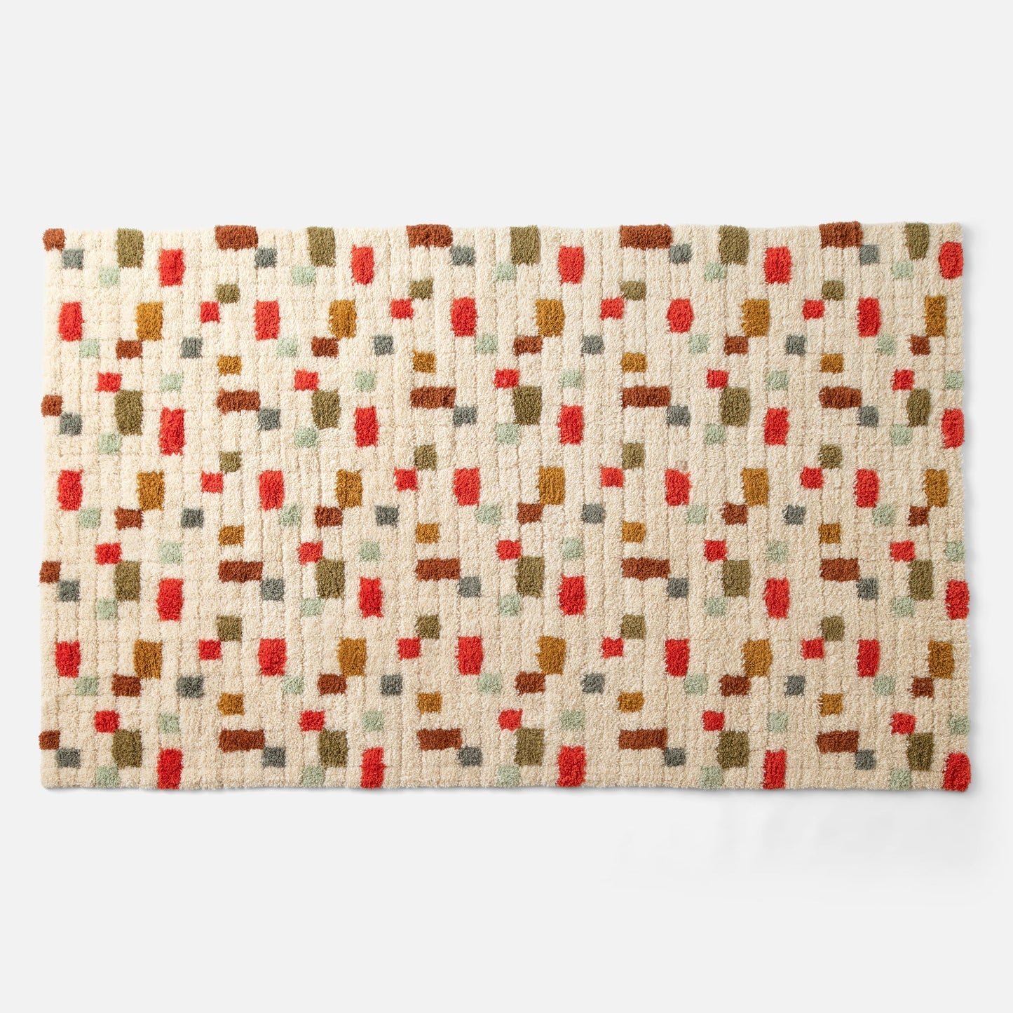 Top view of Pixel Handloom Shag Rug showing high-pile wool texture and multicolored pixel pattern on a natural background
