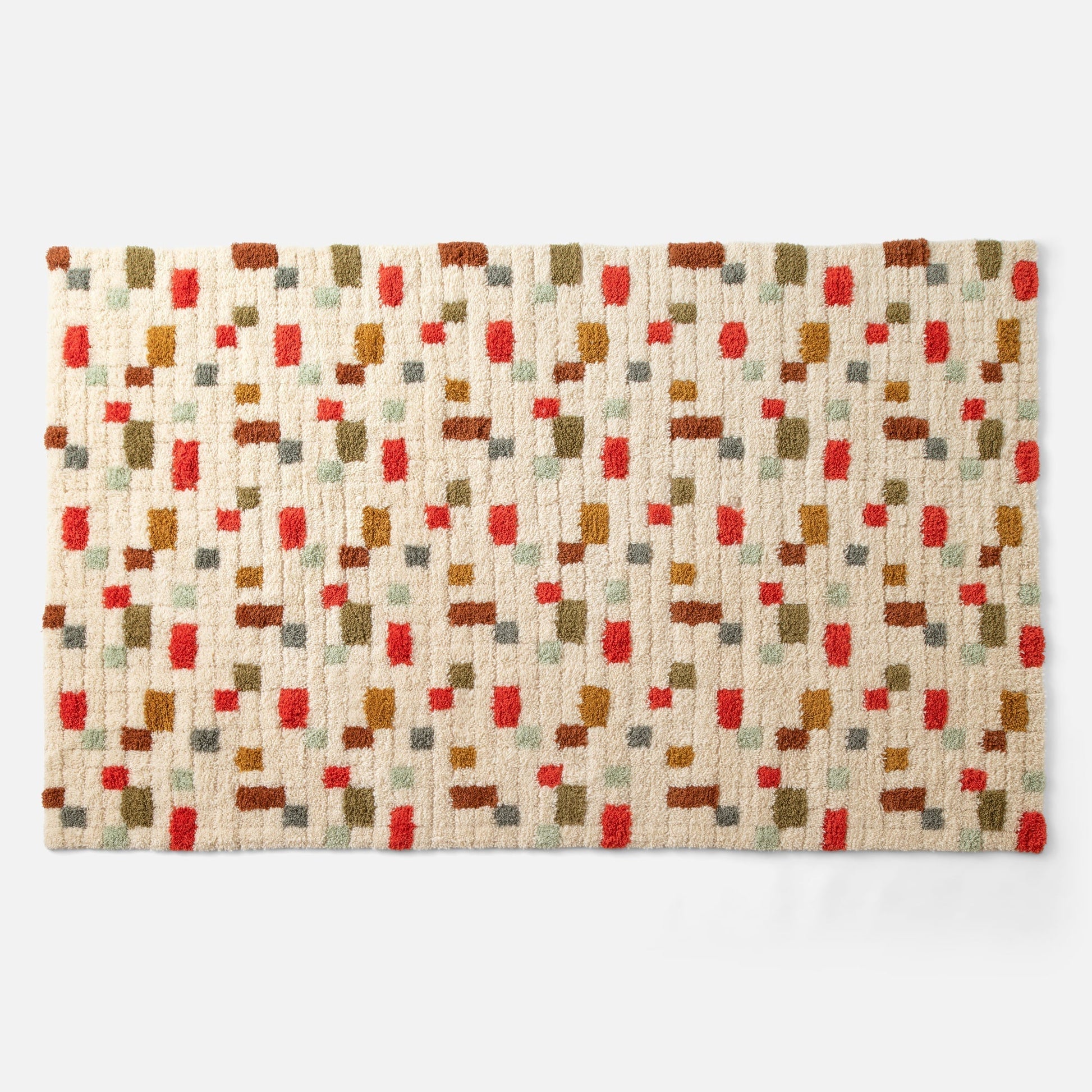 Top view of Pixel Handloom Shag Rug showing high-pile wool texture and multicolored pixel pattern on a natural background