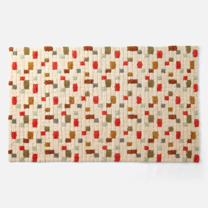 Top view of Pixel Handloom Shag Rug showing high-pile wool texture and multicolored pixel pattern on a natural background