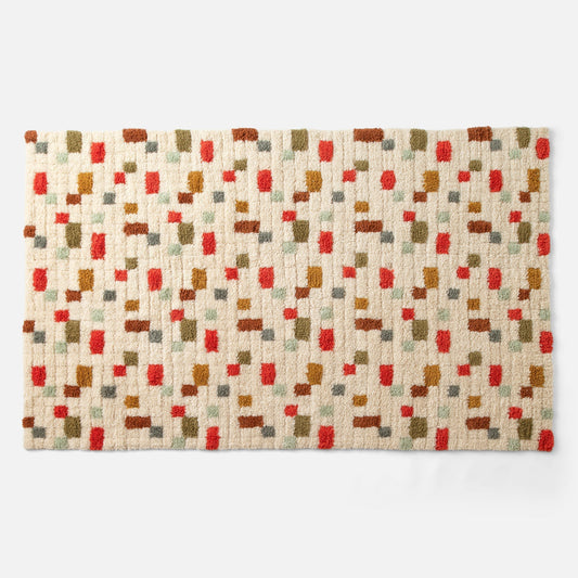 Top view of Pixel Handloom Shag Rug showing high-pile wool texture and multicolored pixel pattern on a natural background