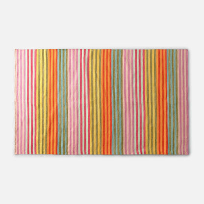 Flat lay of Lisse Performance Rug showcasing multicolor vertical stripes and flatweave texture on a white background